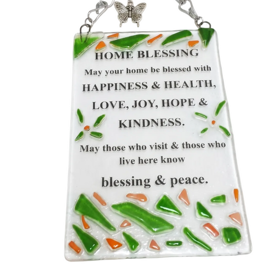 Home Blessing wall hanging in English, handmade fused glass art by Michal Koter Rais Designs, decorated with green and orange glass fragments and a butterfly charm